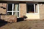 Side extension to modern semi-detached property, matching like materials, with dormer windows and flat roofs.