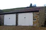 Garage extension to a grade II listed property in a conservation area. Built in White Lias and Doulting stone, use of reclaimed materials and natural stone Copings.